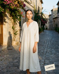 Ivory linen smock midi dress on a Mediterranean street, golden hour